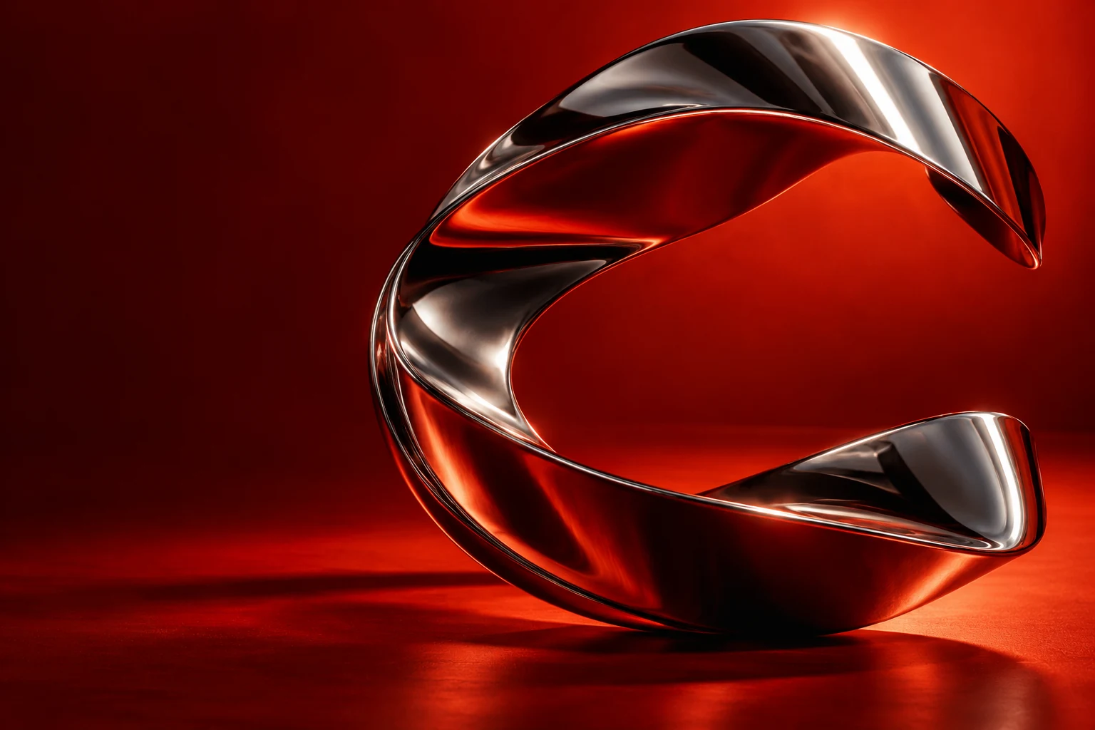 A flowing polished chrome sculpture against a vivid vermilion background